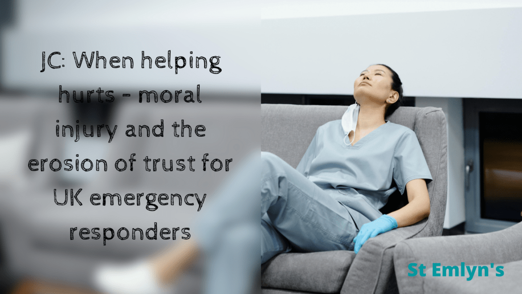 Nurse or doctor in light blue scrubs lying back on a sofa staring at the ceiling
