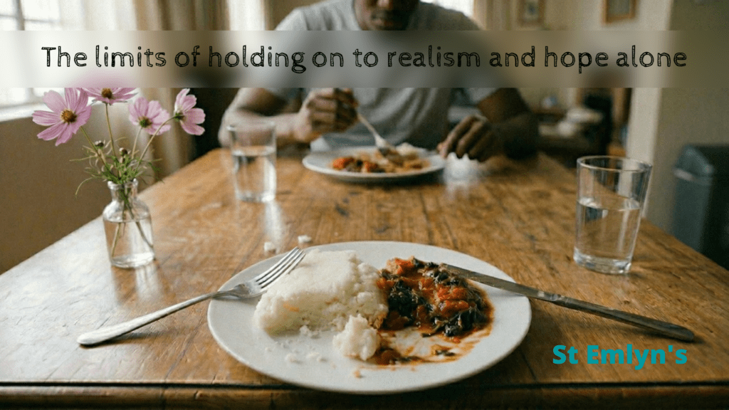 Two people share a simple meal of pap and shebo at a wooden table, seen from the diner's point of view, illustrating a piece on holding on in emergency medicine.